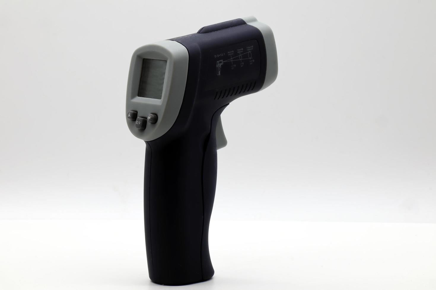 Infrared laser thermometer isolated on white. It measures temperature without contact. photo