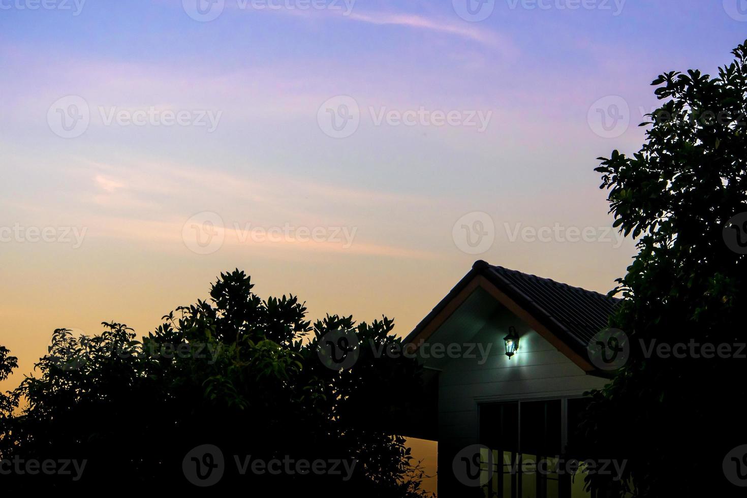 Silhouette of house and tree in the morning photo