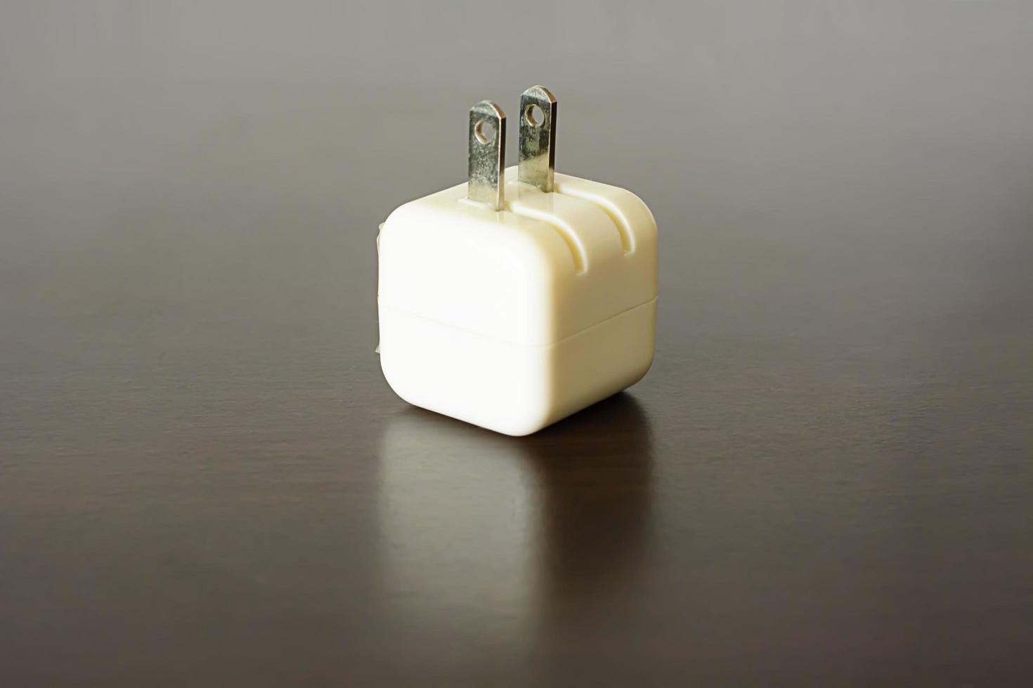 The white usb charger on wood background. photo