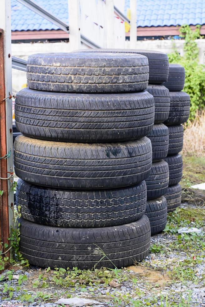 The old tires stacked in the field photo