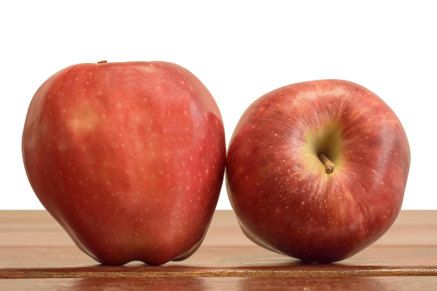 Two apples isolated on the wood table. photo