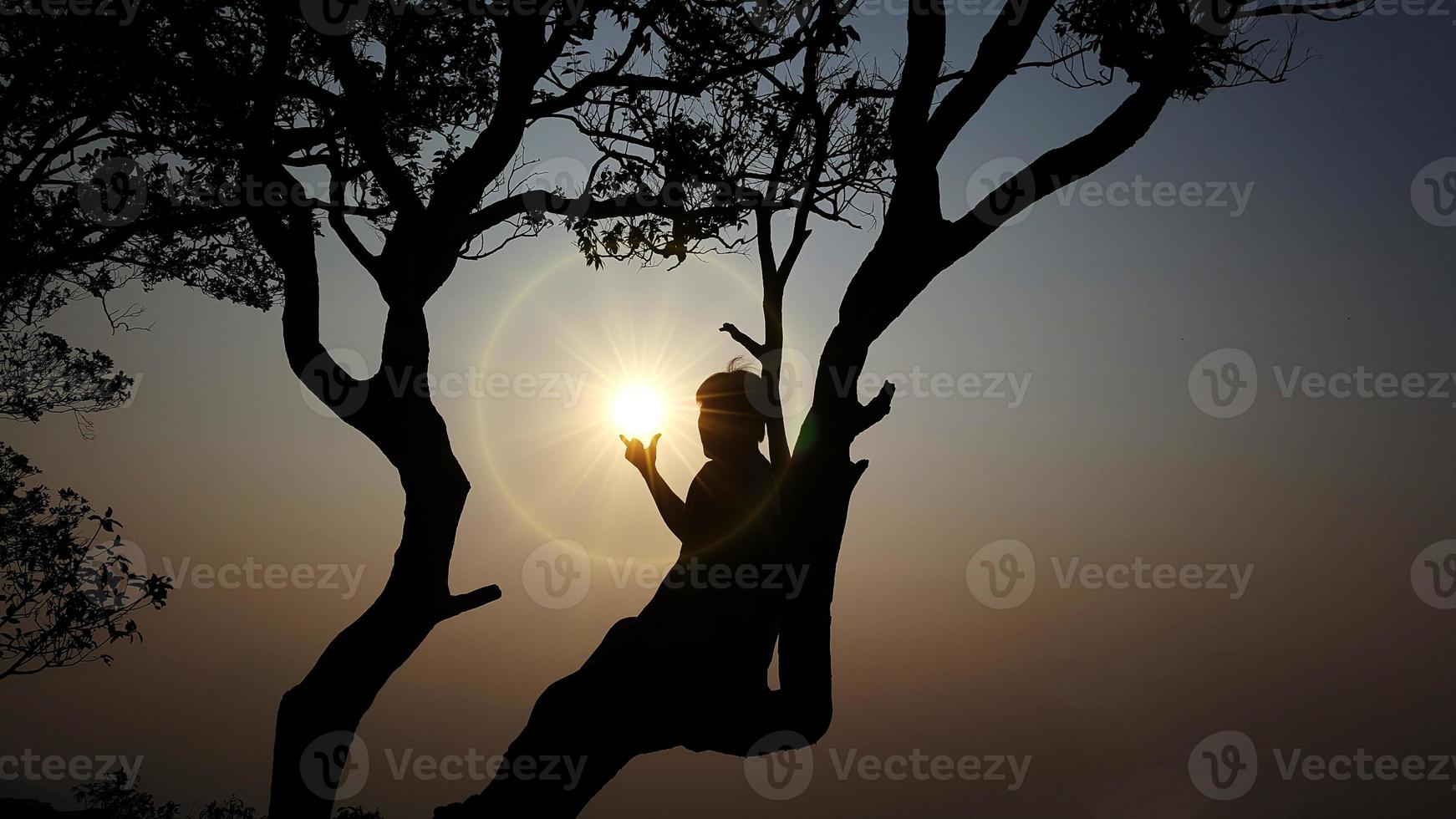 Men's silhouette at sunset on nature background. photo