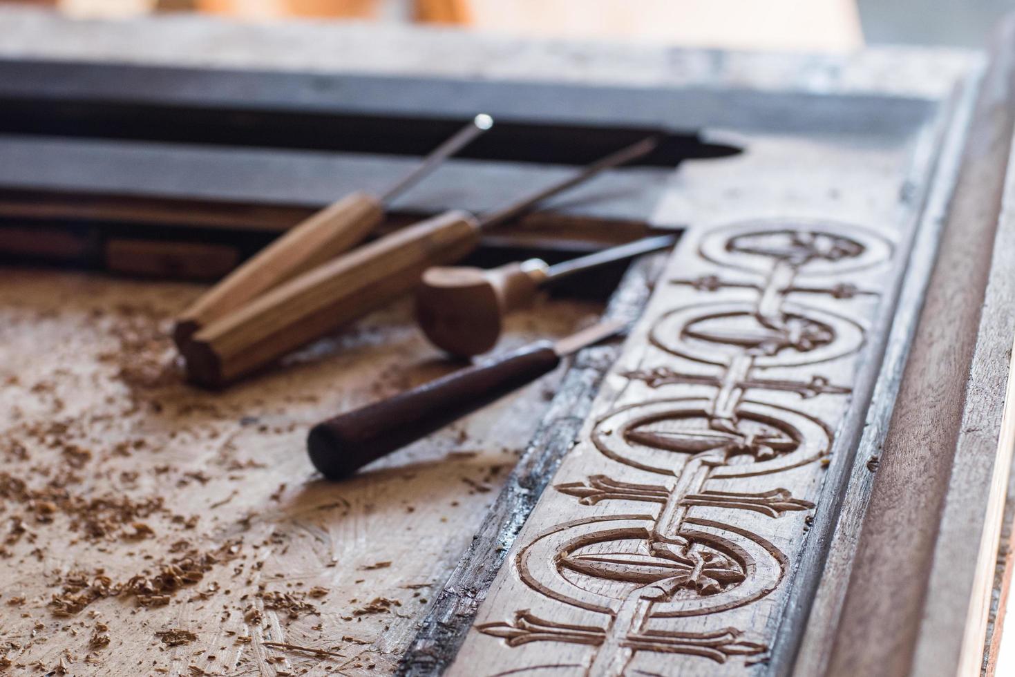 Woodcarving workshop, close up picture of tools and wood photo