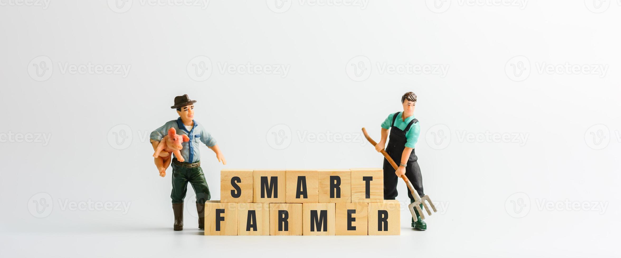 Smart farmer concept. Cube wooden block with the text of smart farmer with a small figure. photo