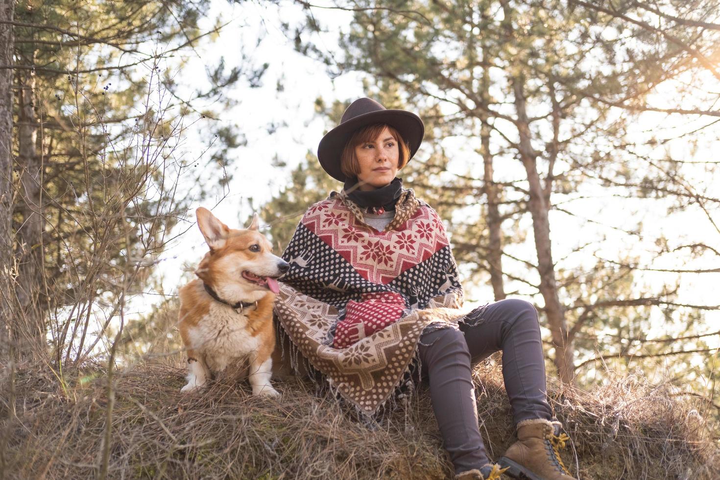 Young hipster woman travel with corgi dog photo