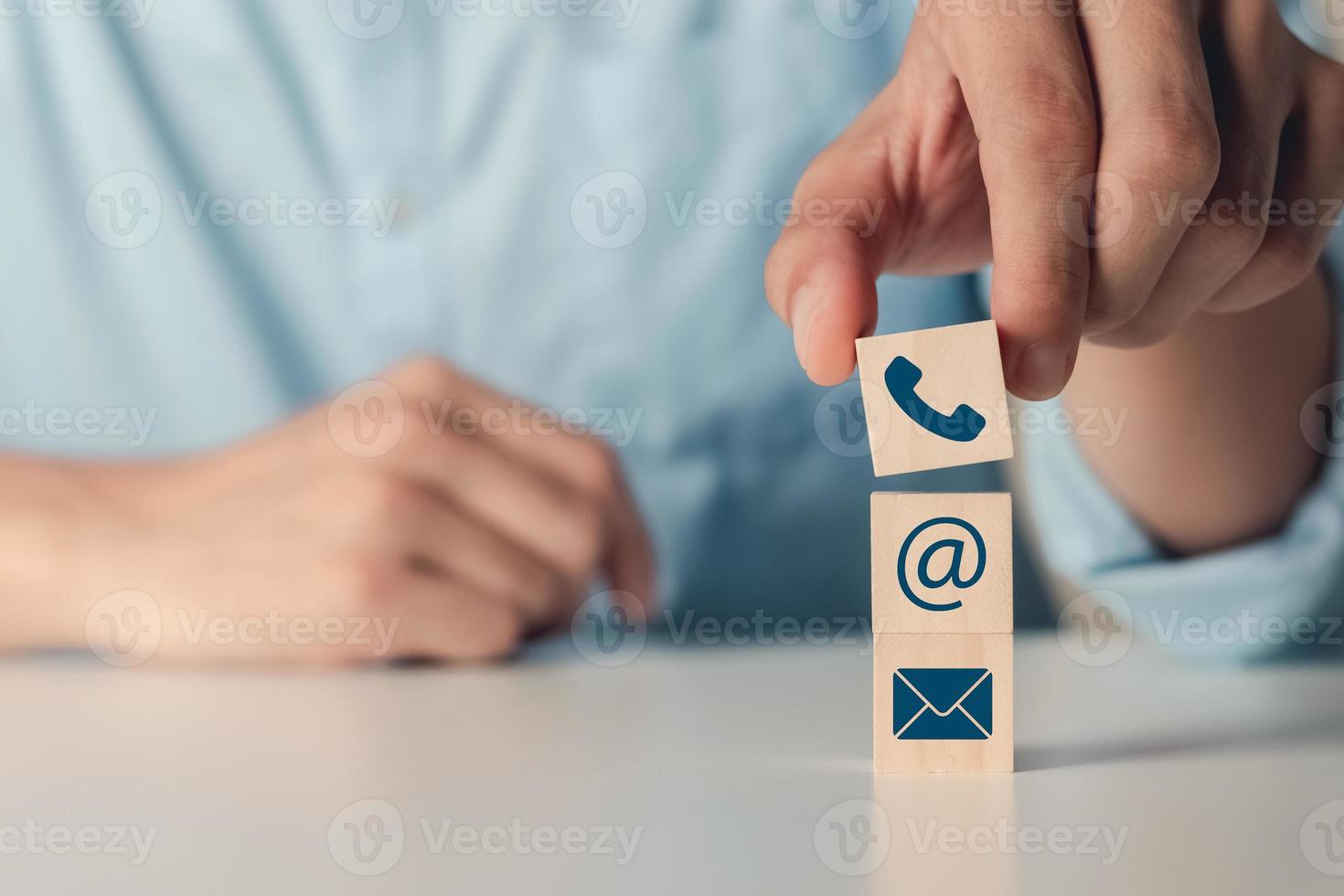 Hand putting wood blocks Cube Symbol Phone, Email, Address. contact or email marketing concept. photo