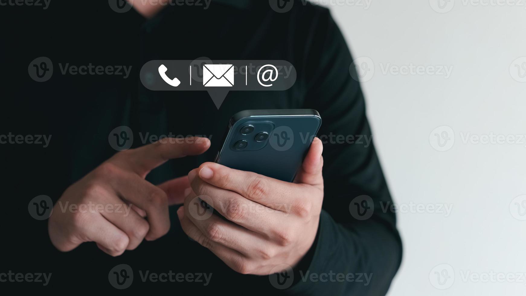 Hand of Businessman holding mobile smartphone. Contact Us, customer support concept. copy space. photo