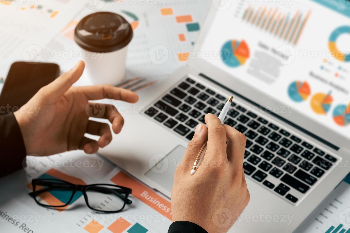 accounting concept. businessman working using a laptop with analyzing finance sales data and economic growth graph chart. photo