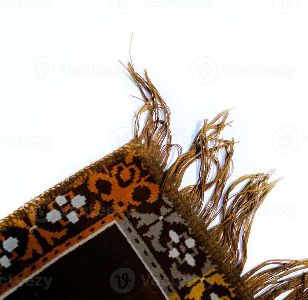 Prayer rug sajadah isolated  on white background photo