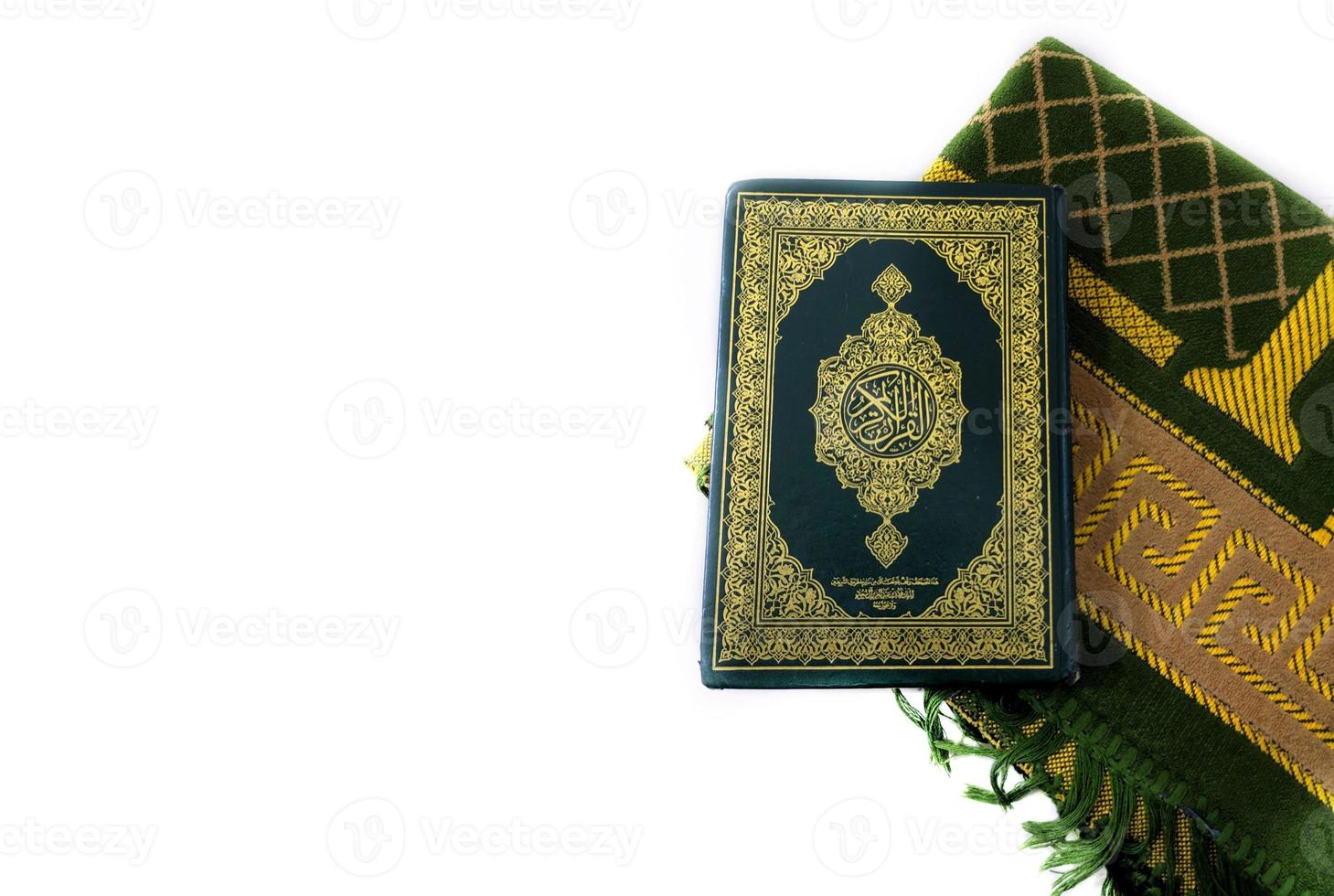 Photos of the Koran and prayer rugs ready for Ramadan.  Arabic on the cover is translated as the Qur'an
