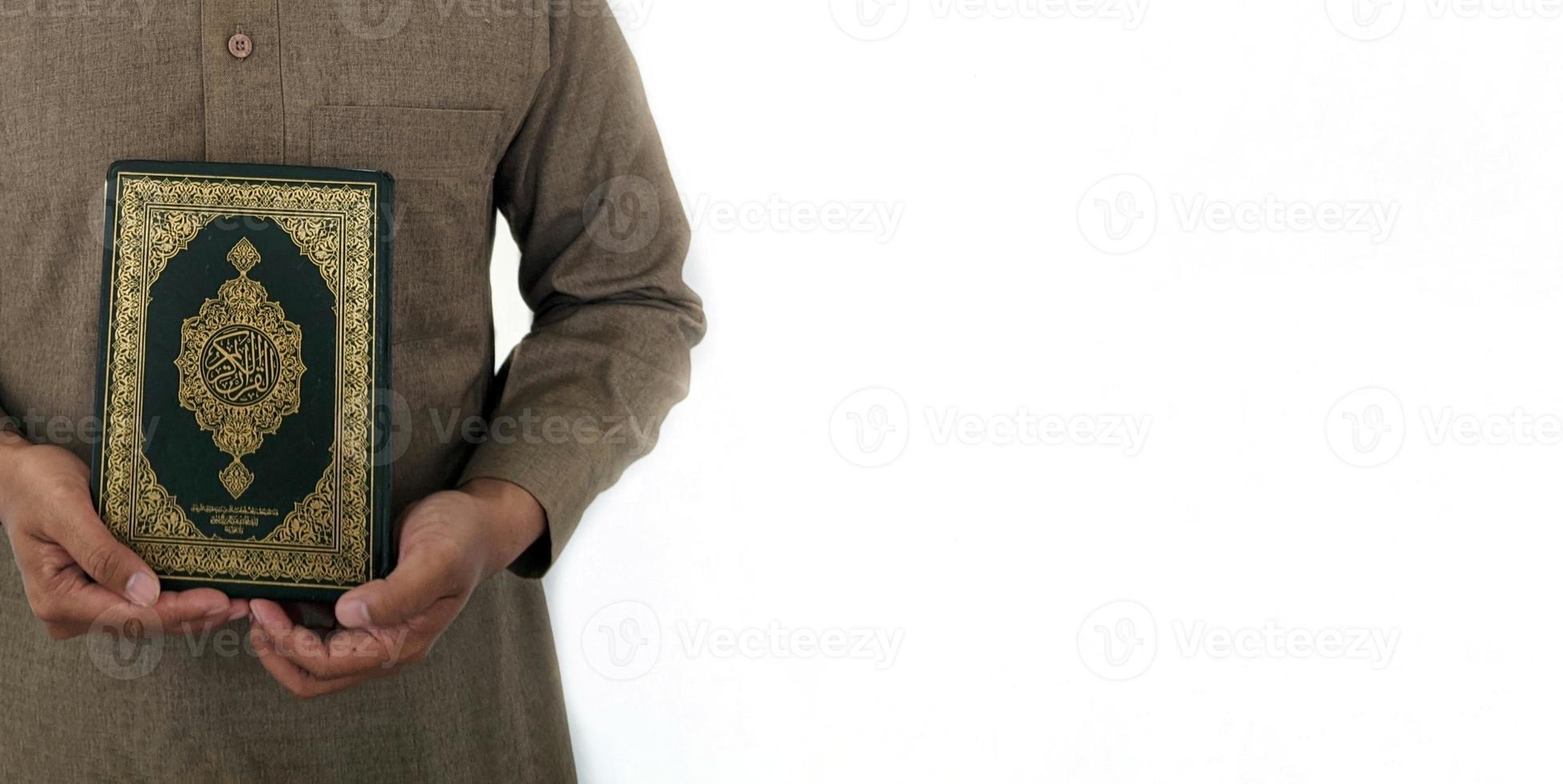 Man Holding and reading quran. Islamic Background photo