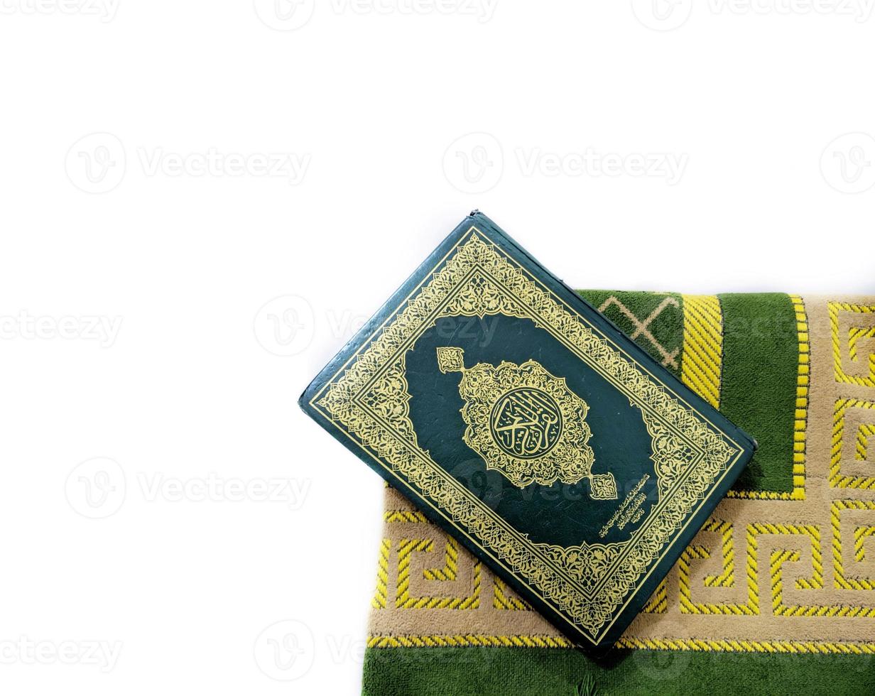 Photos of the Koran and prayer rugs ready for Ramadan.  Arabic on the cover is translated as the Qur'an