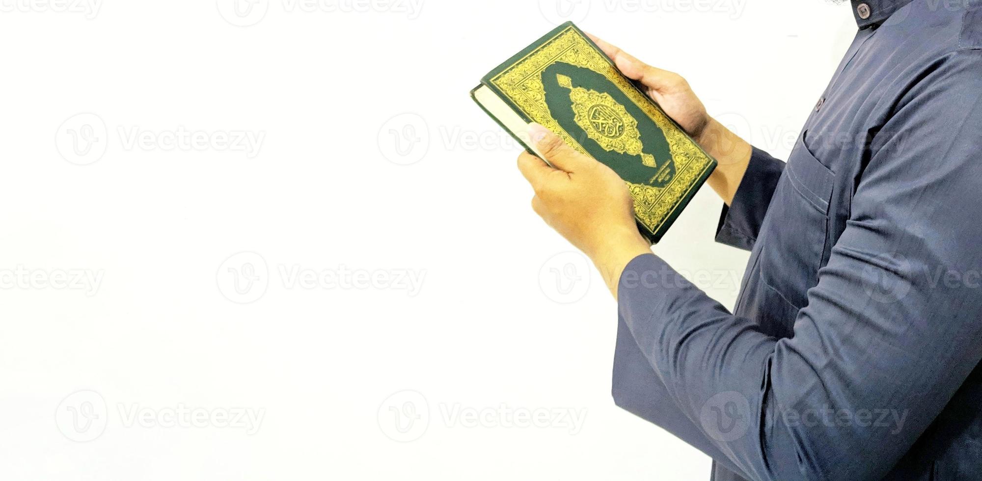 Man Holding and reading quran. Islamic Background photo