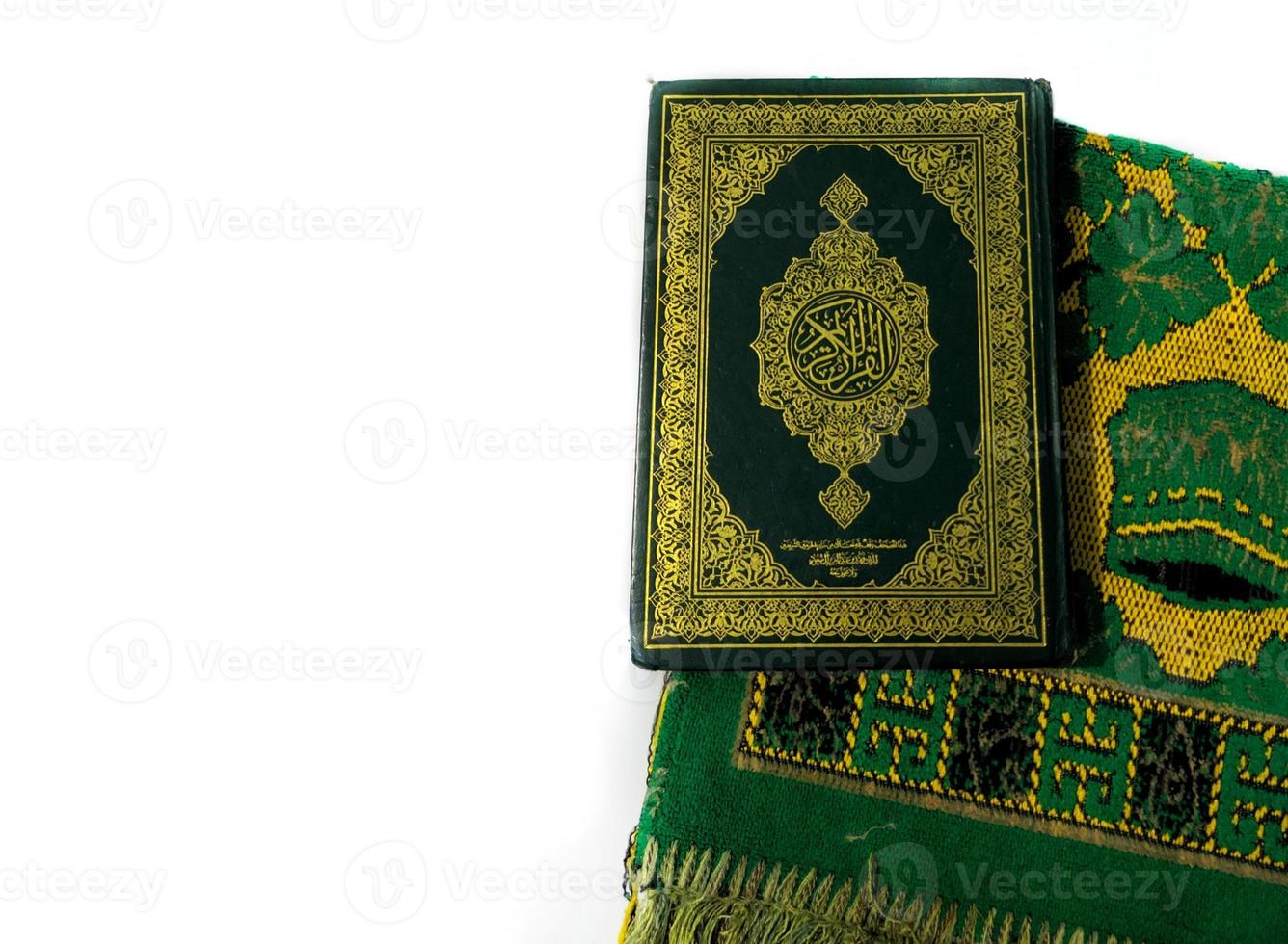 Photos of the Koran and prayer rugs ready for Ramadan.  Arabic on the cover is translated as the Qur'an