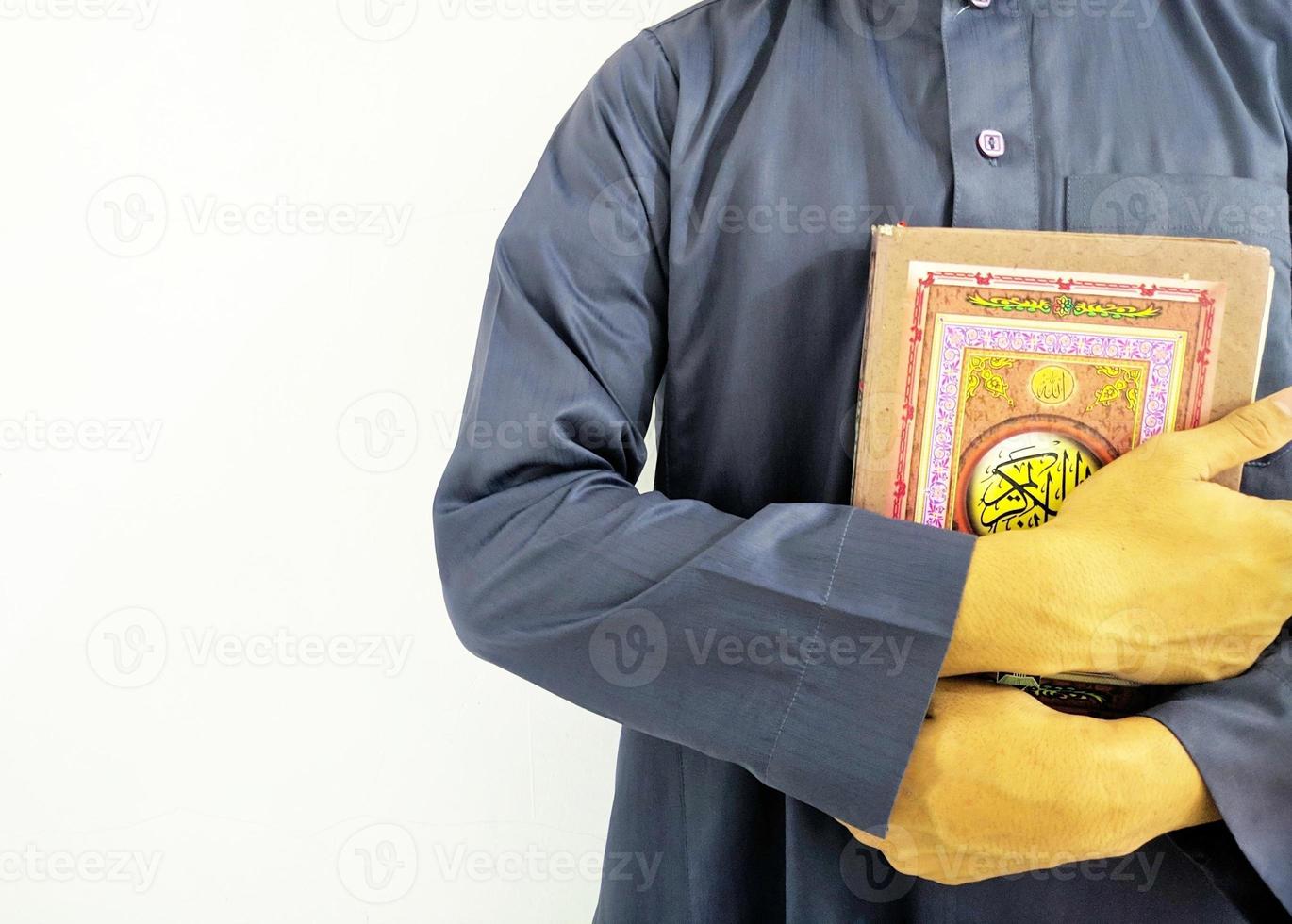 Man Holding and reading quran. Islamic Background photo