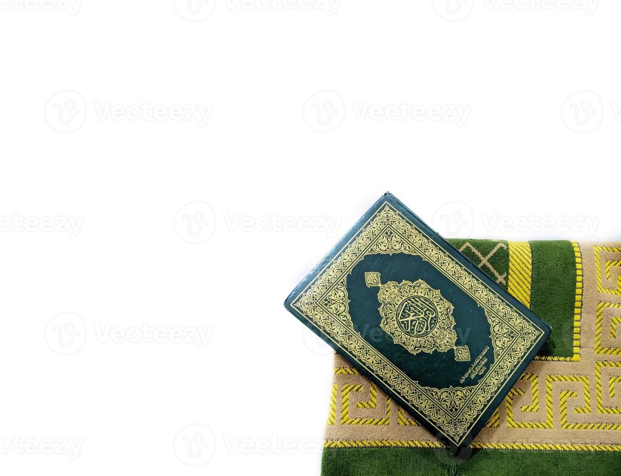 Photos of the Koran and prayer rugs ready for Ramadan.  Arabic on the cover is translated as the Qur'an