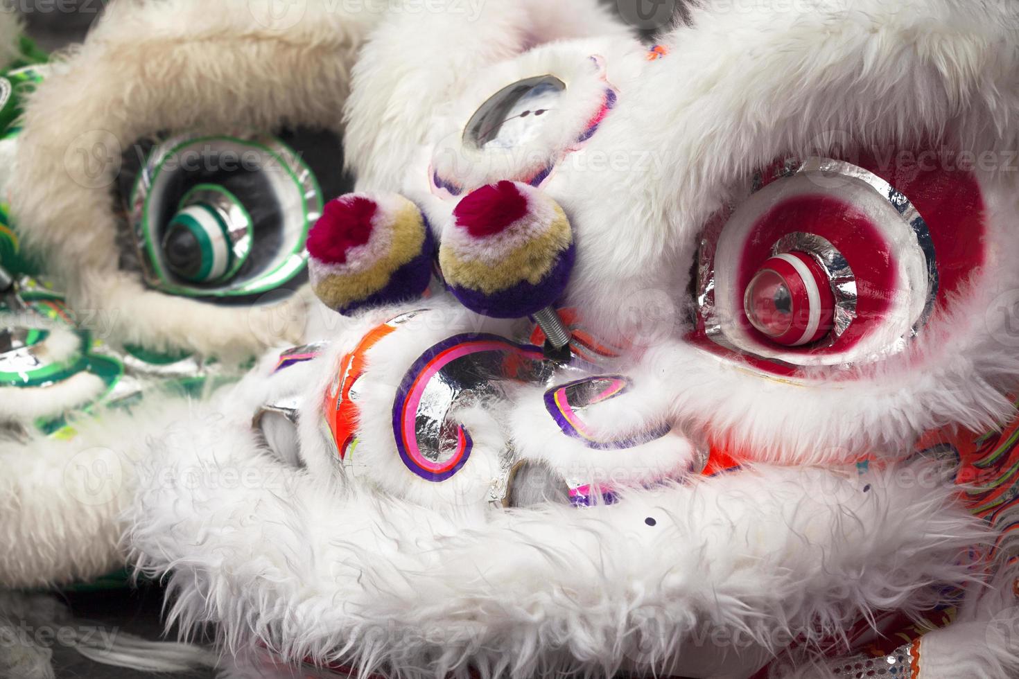 Close up on two lion dancing costume heads photo