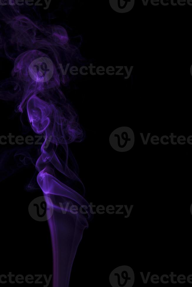 Purple smoke swirling on a black background photo
