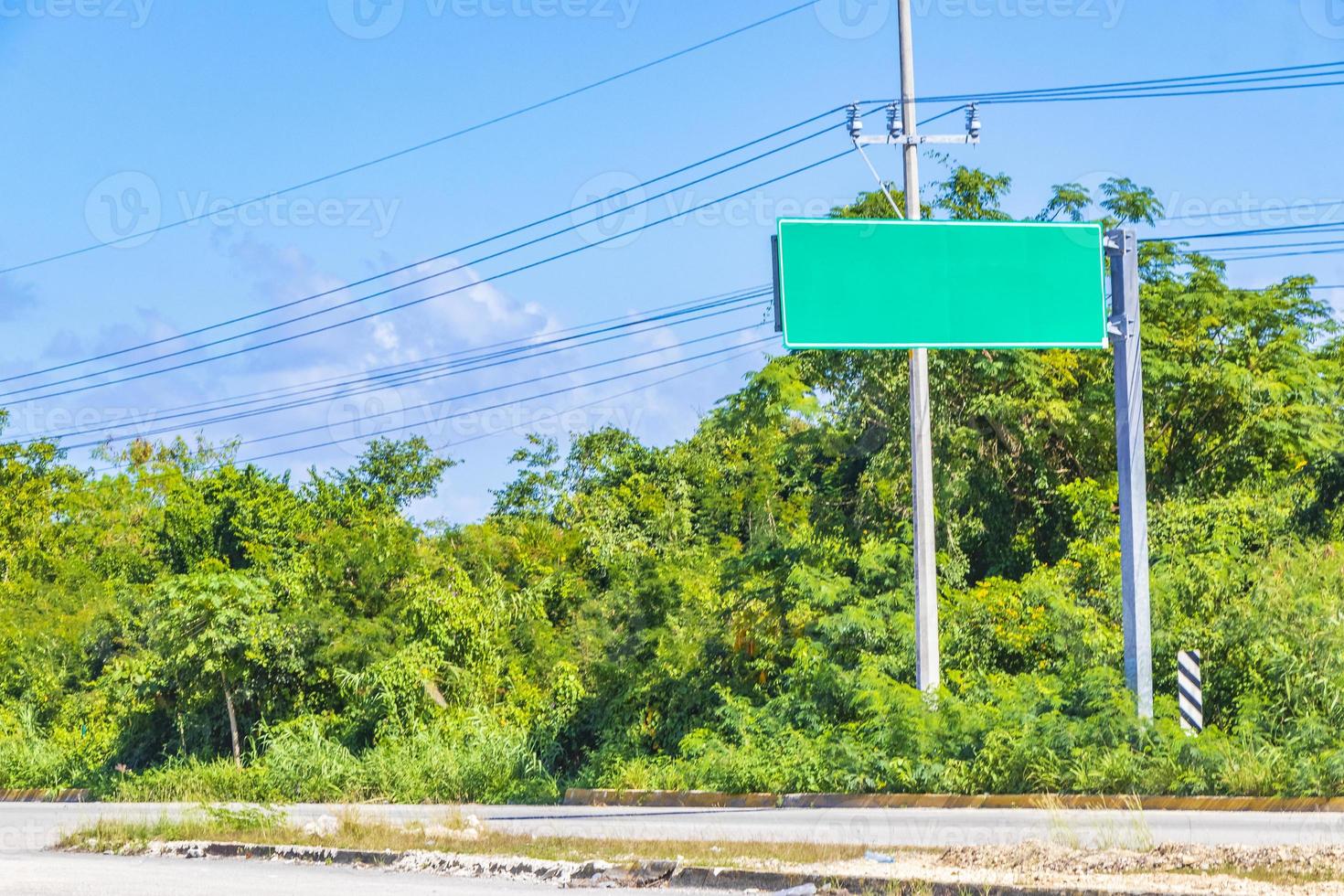 Directional green blank empty road sign in Tulum Mexico. photo