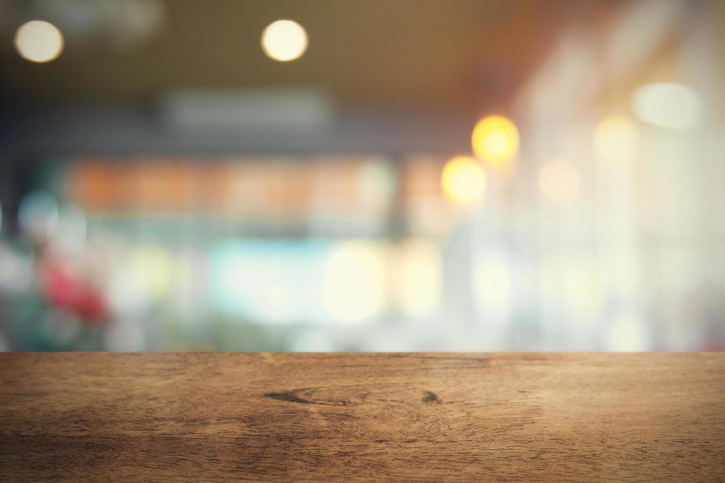 empty wood table on blur coffee shop background photo