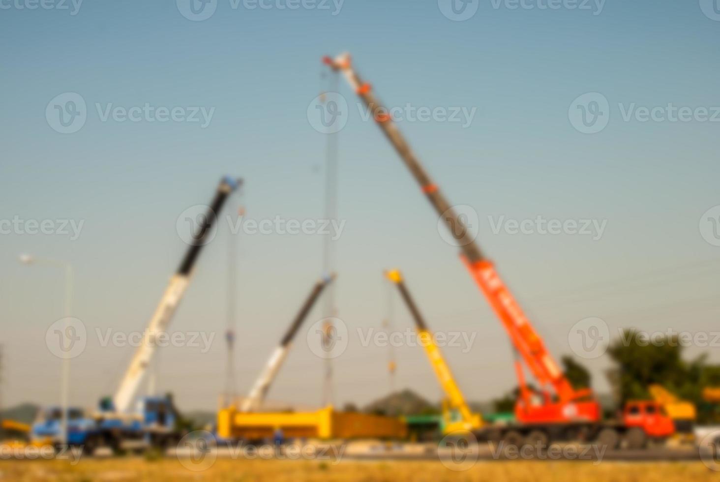 blur background mobile crane lifting up crane girder installation photo