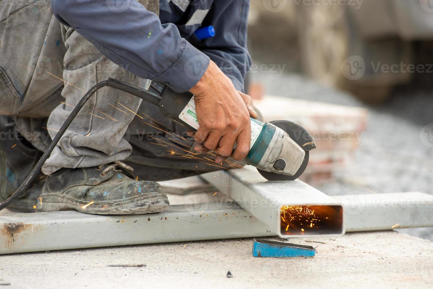 Man polishes metal with a grinding machine photo