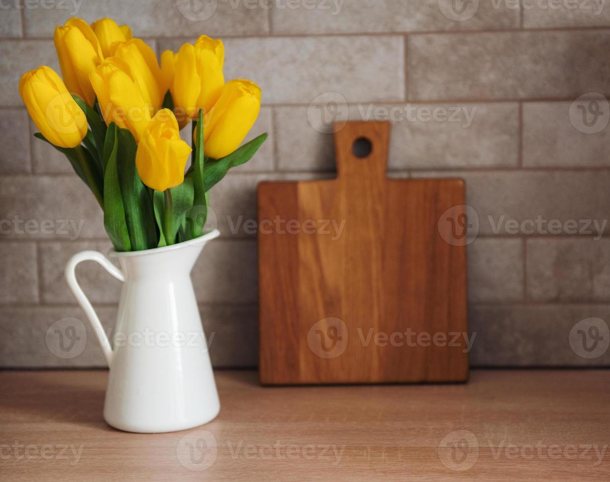 Beautiful tulip flowers  on table at kitchen photo