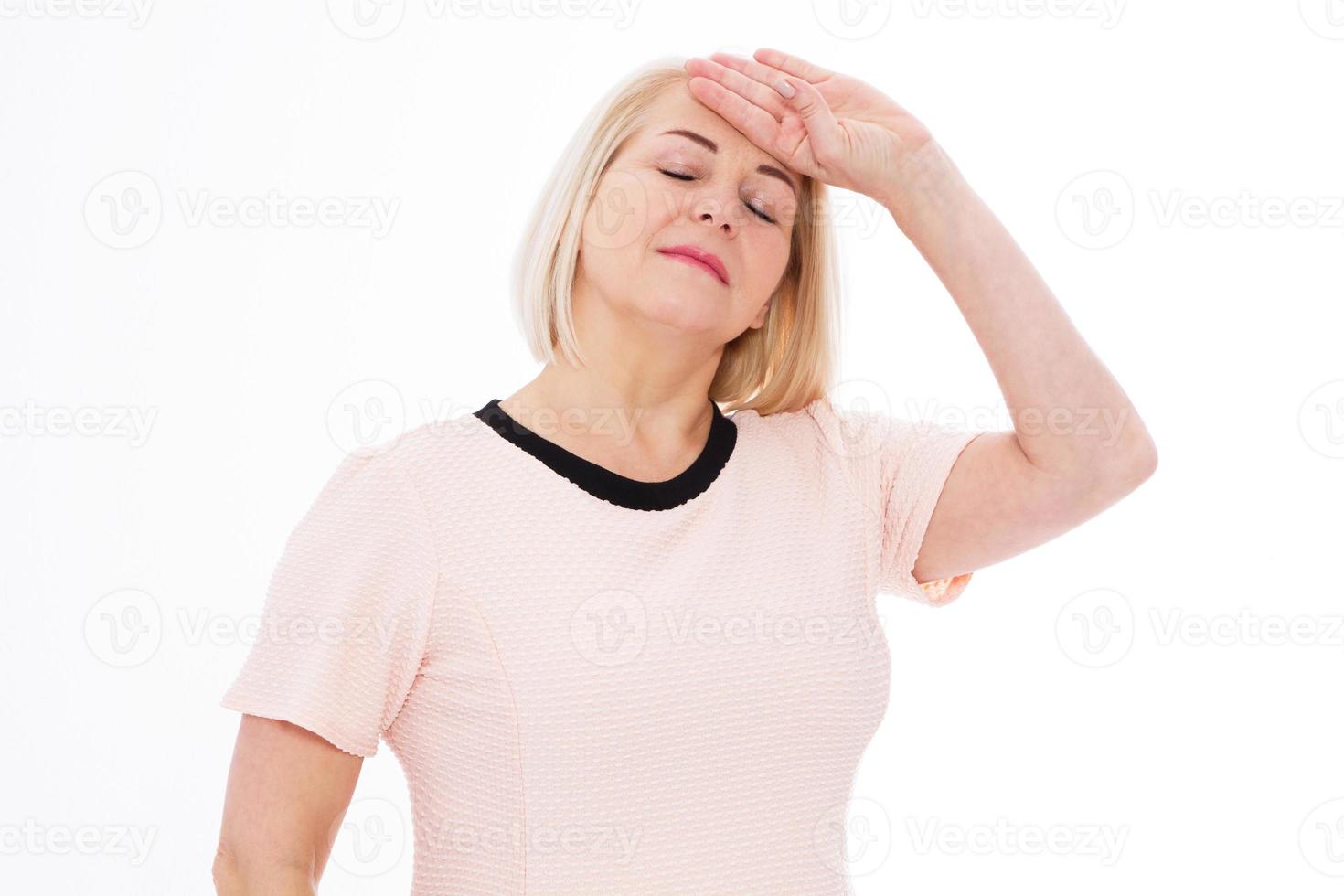 Covid 14 coronavirus simptome Middle age woman head pain migraine, A middle-aged woman stands and touches her head with her hand - she has a temperature or head ache, health care concept photo