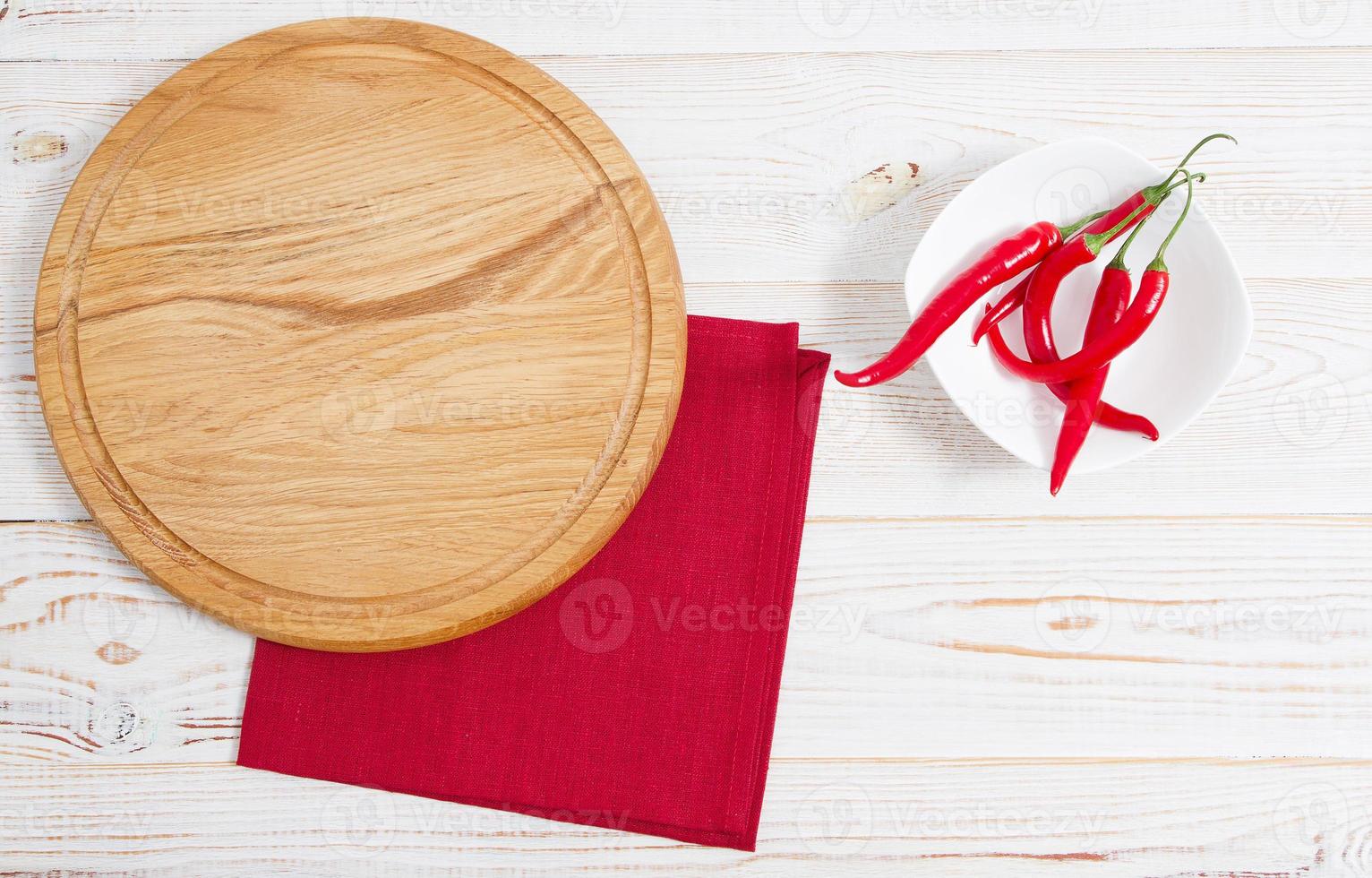 Napkin and board for pizza on wooden desk closeup, tablecloth. Canvas, dish towels on white wooden table background top view mock up. Selective focus photo