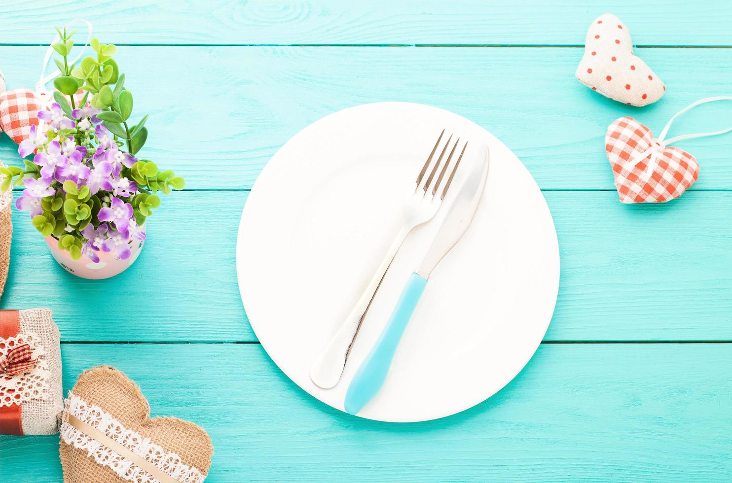 Valentines day set with silverware. Valentine day love beautiful. Romantic dinner, tableware and hearts on wooden background.Top view. photo