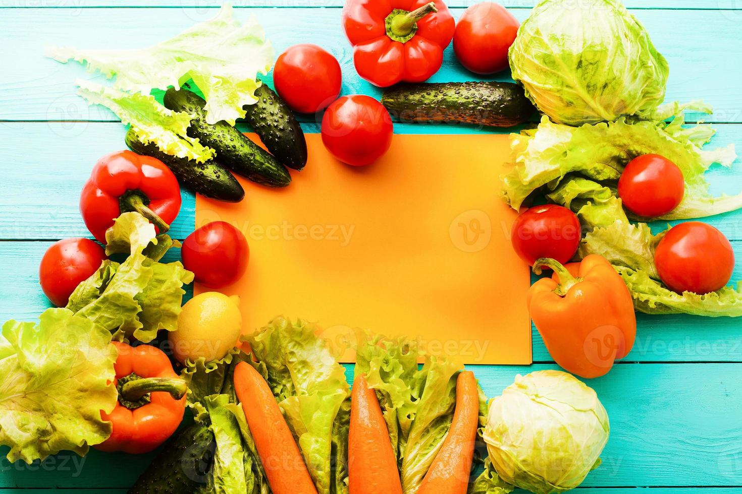 Different vegetables on kitchen table with recipe list and copy space. Top view photo