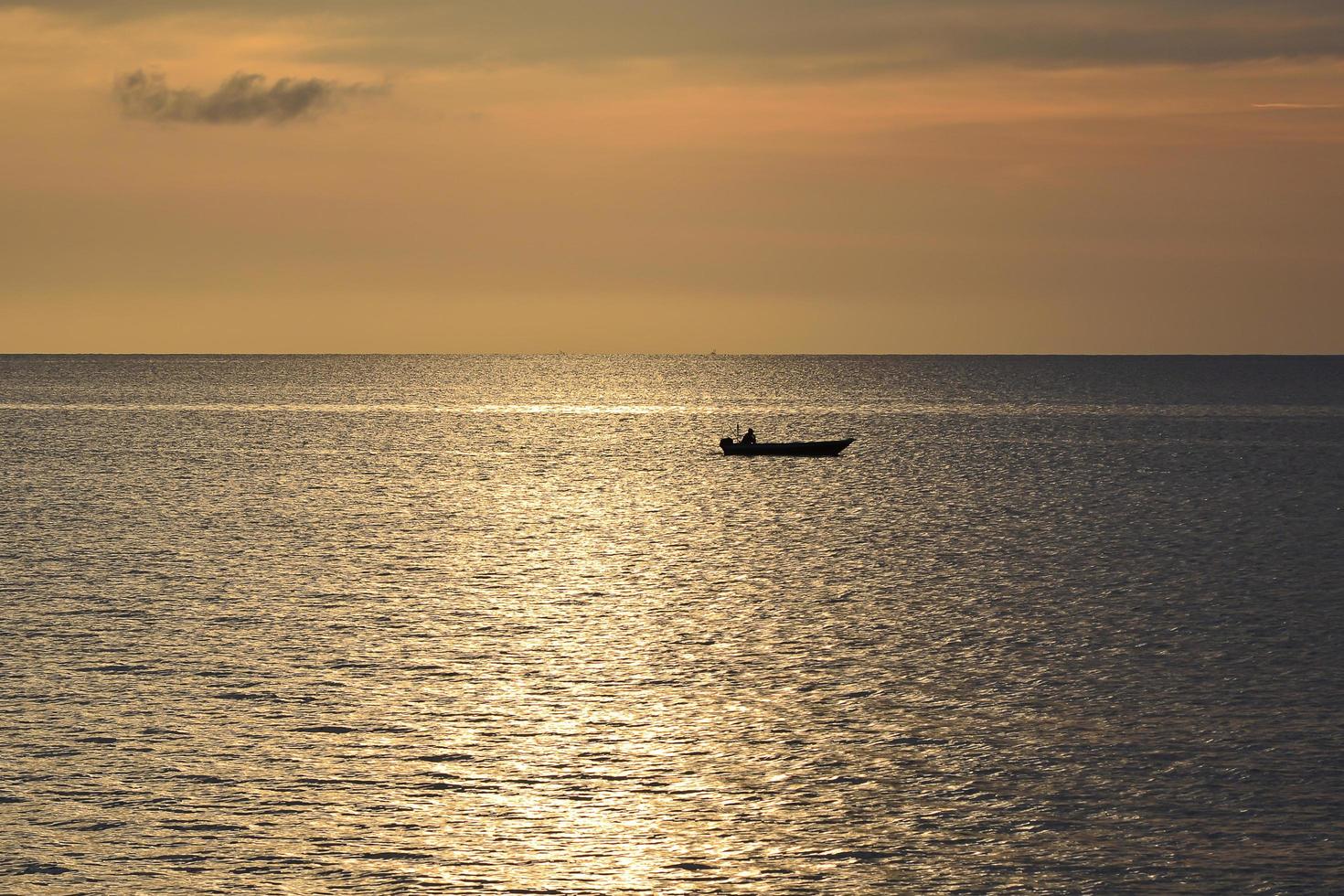 Evening Sunset and fisherman fishing from afar in Tanjung Aru Beach, Sabah. photo