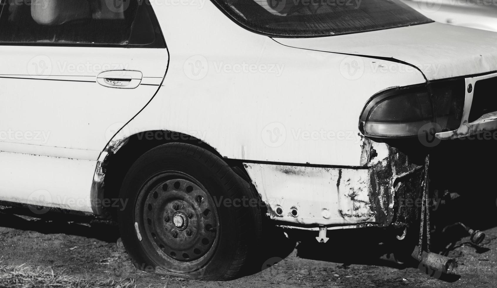 rusty abandoned car with flat wheels photo