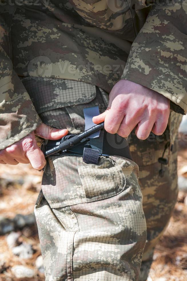 Army soldiers practicing military tourniquet application. photo