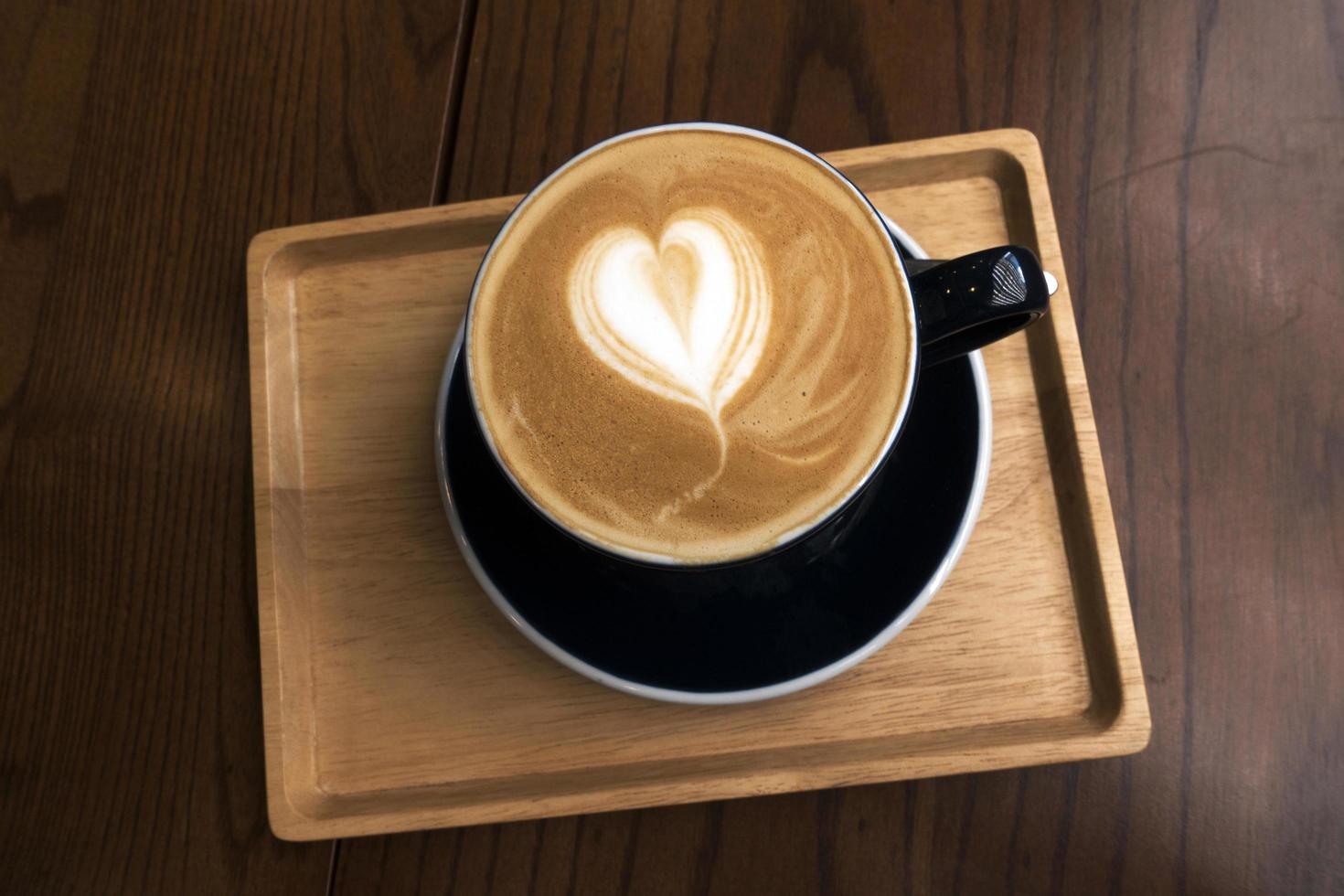 Hot coffee on wooden table photo