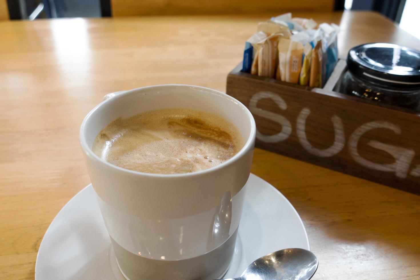 Hot coffee on wooden table photo
