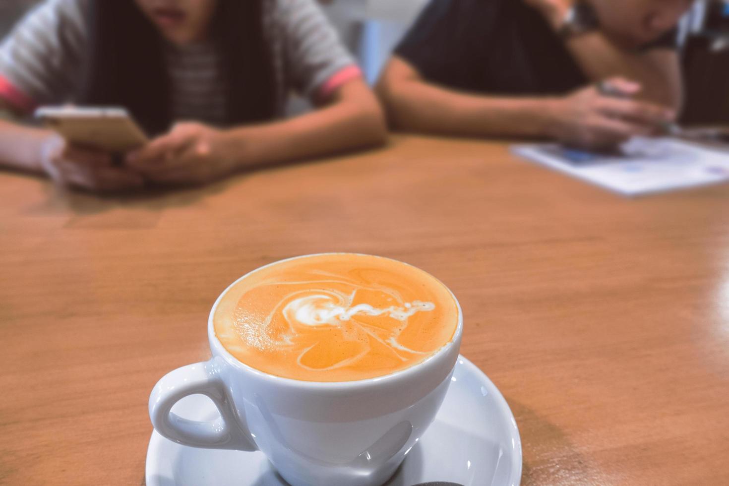 Hot coffee latte on a wooden table. photo