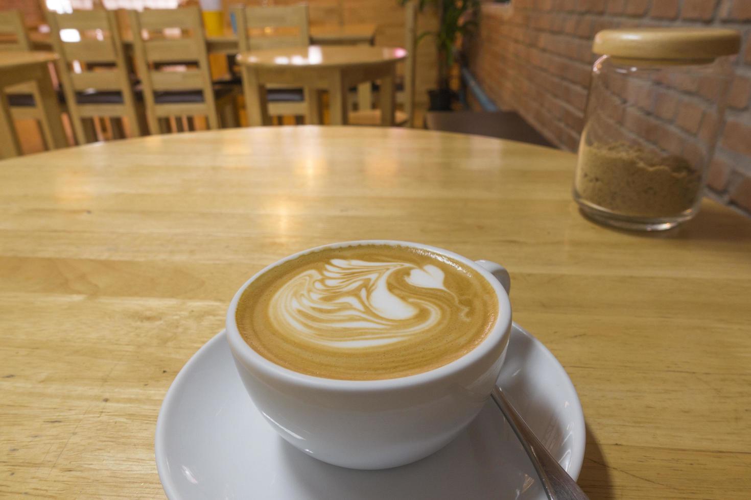 Hot coffee on wooden table photo