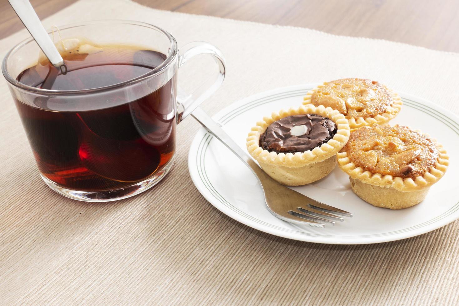 Tea time with hot tea and dessert tarts photo