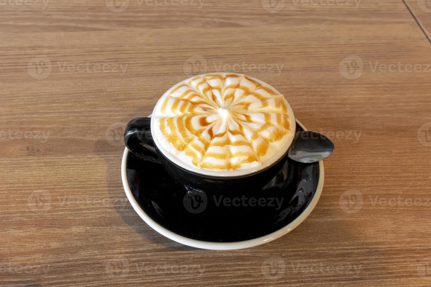 Hot coffee on wooden table photo