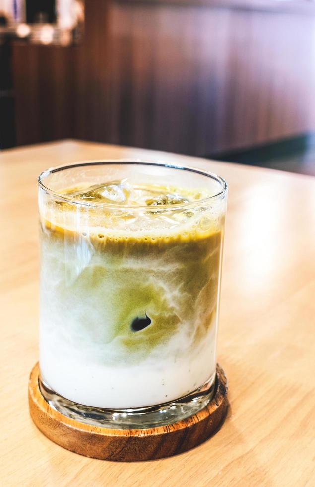 Ice matcha latte on a wooden table. photo