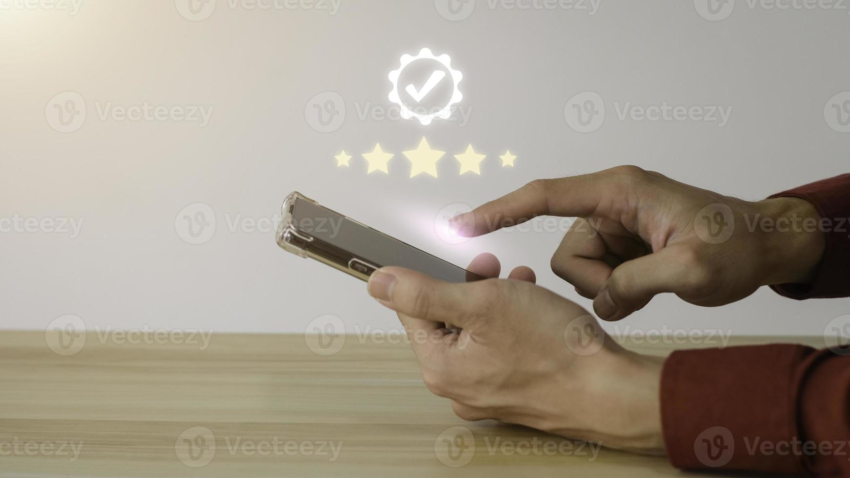 Close up on Customer Man Hand press on smartphone screen with gold five star comment icon and excellent press level for best rating in business idea service review. photo