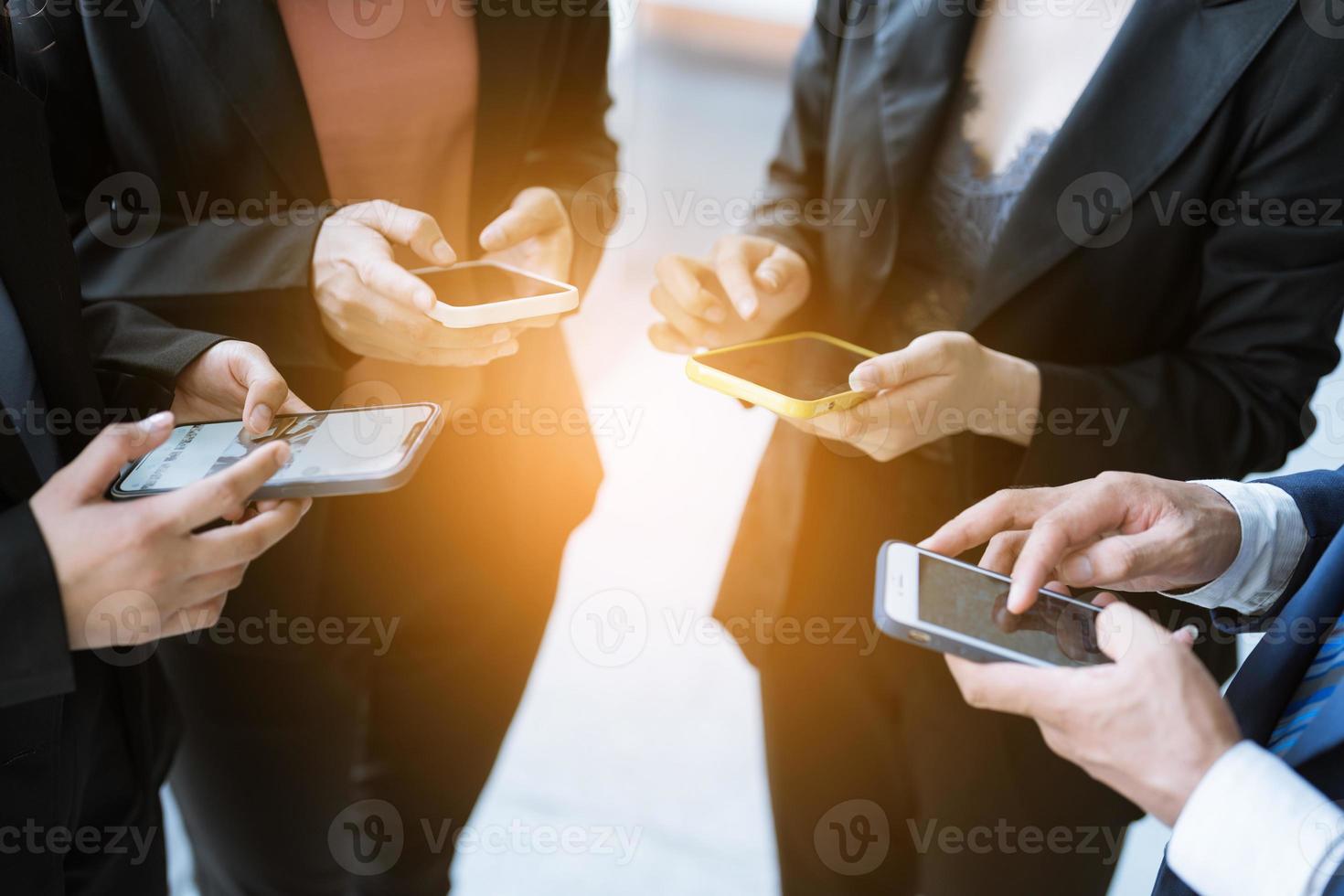 Group of young business people standing and using smartphone together concepts communication. photo