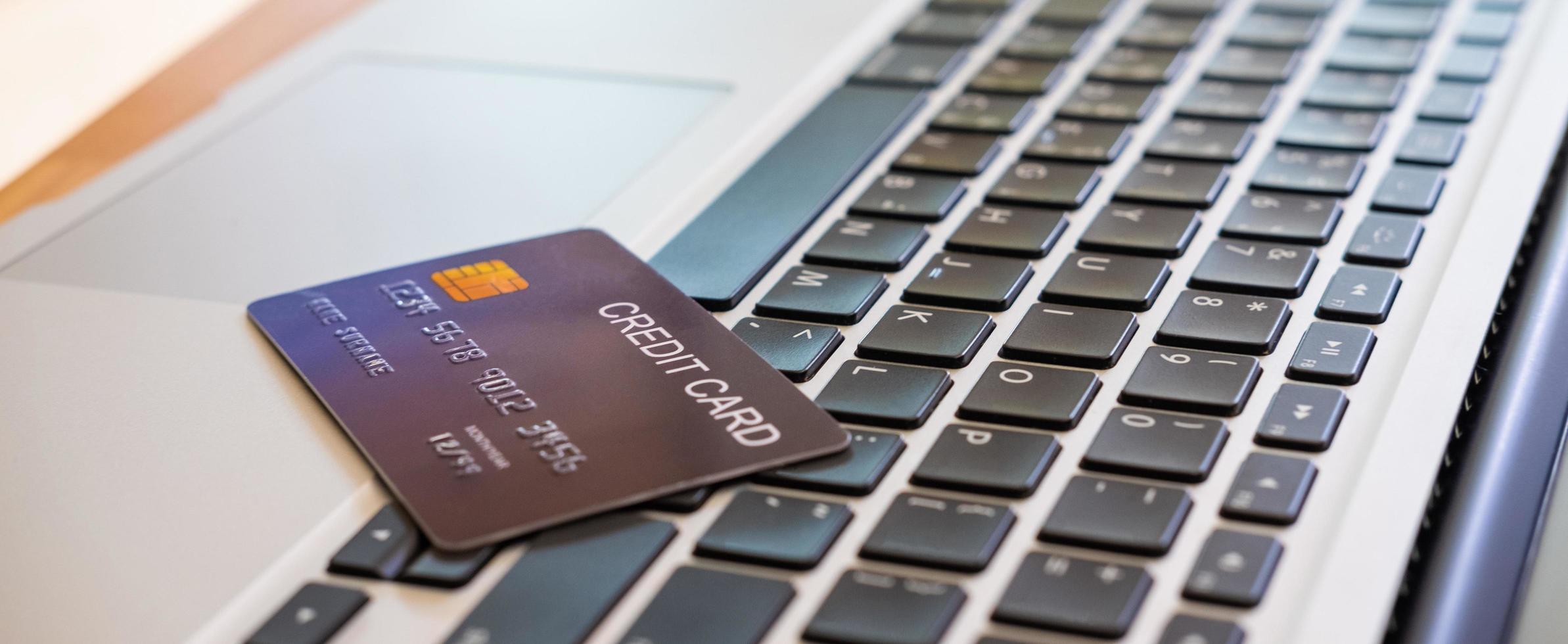 Banner image of credit card on computer keyboard. Online financial transaction for payment with technology and security concept. photo