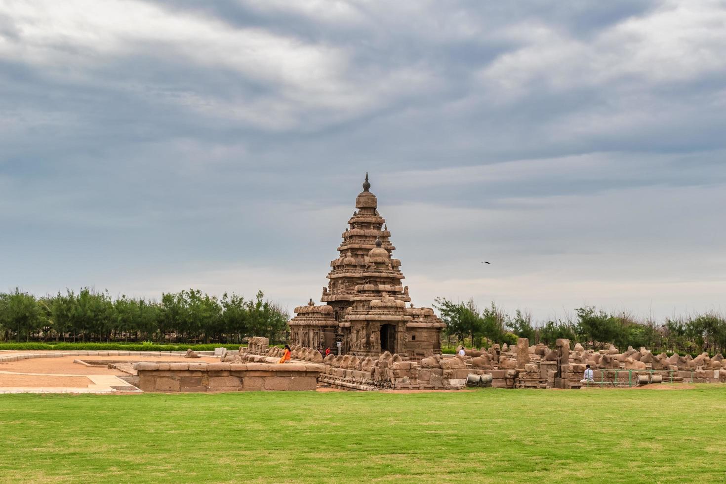 A distant view of the exterior facade of the ancient Shore Temple on a cloudy day. photo