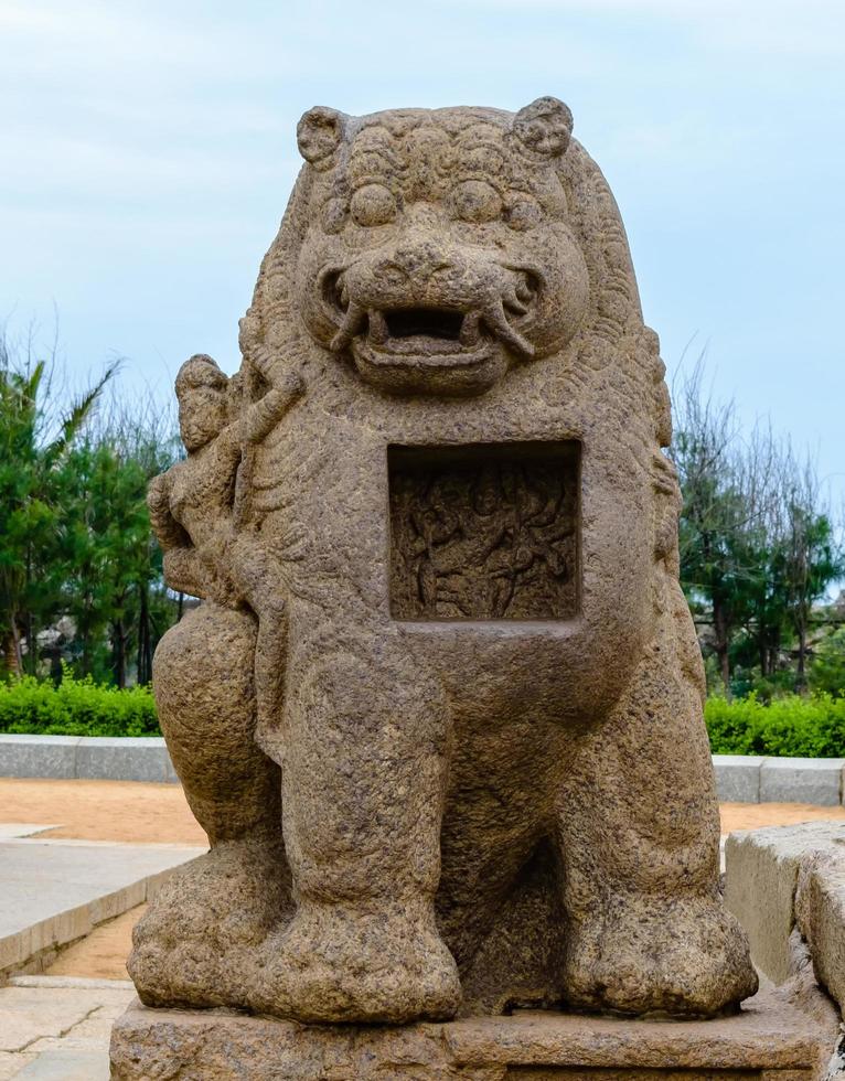 An ancient stone sculpture of a lion and a Hindu deity inside the 8th century Shore Temple in Mamallapuram in Tamil Nadu, India. photo