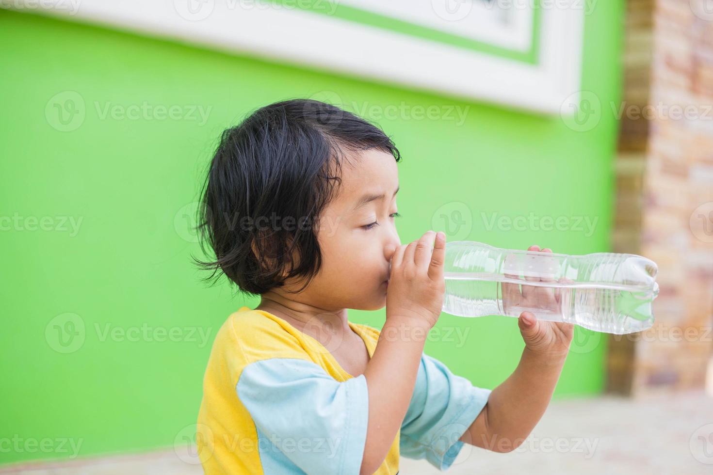 Thirsty Girl Drinking Water Outdoors photo
