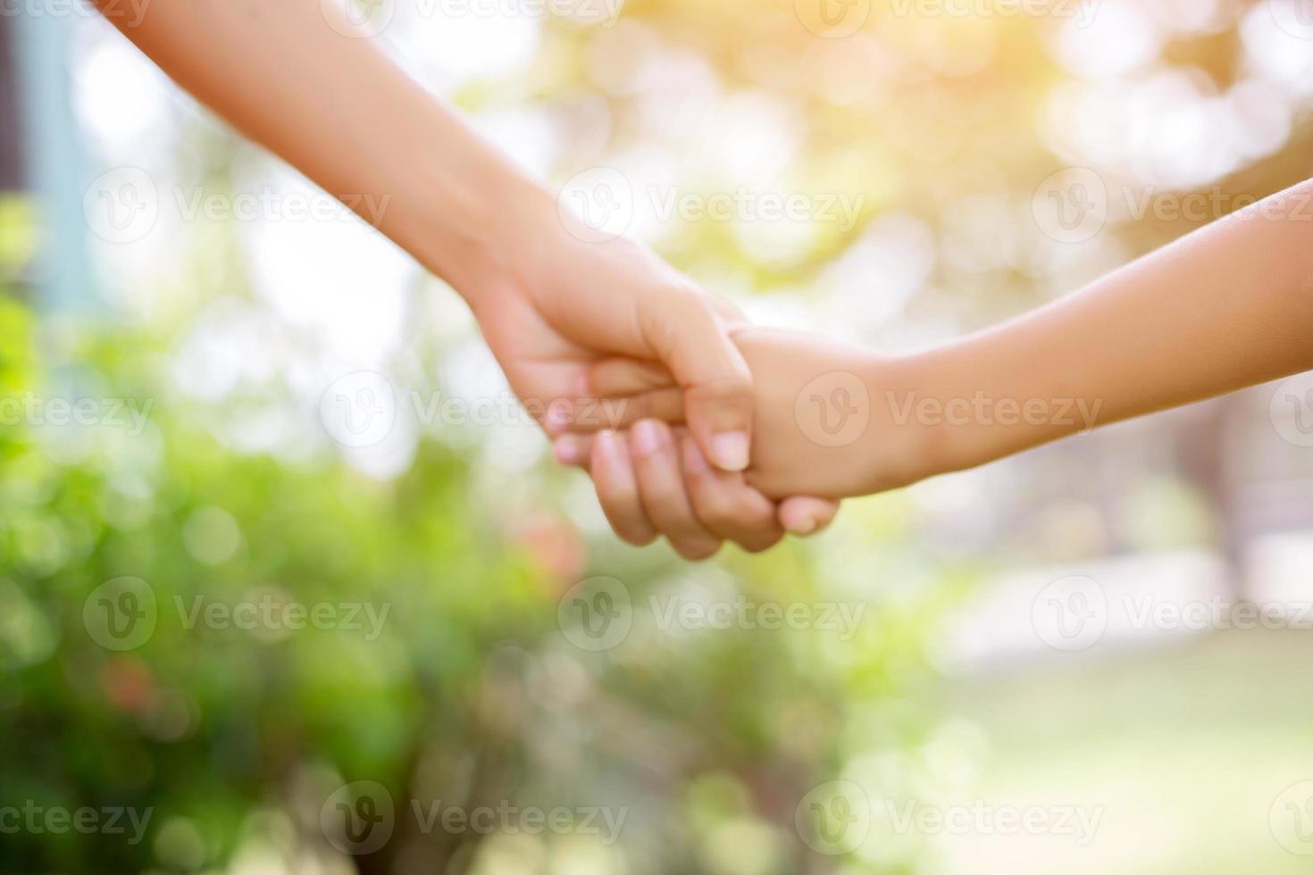 Happy couple holding hands in the sunset photo