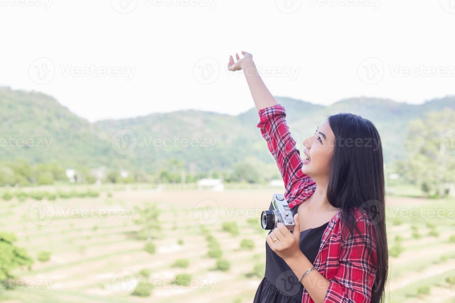 Young hipster woman photographer holding a vintage camera. photo