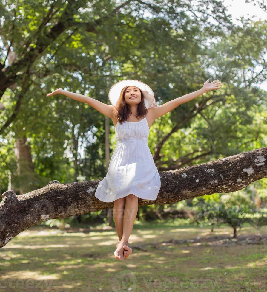 Young teen girl sitting on tree photo